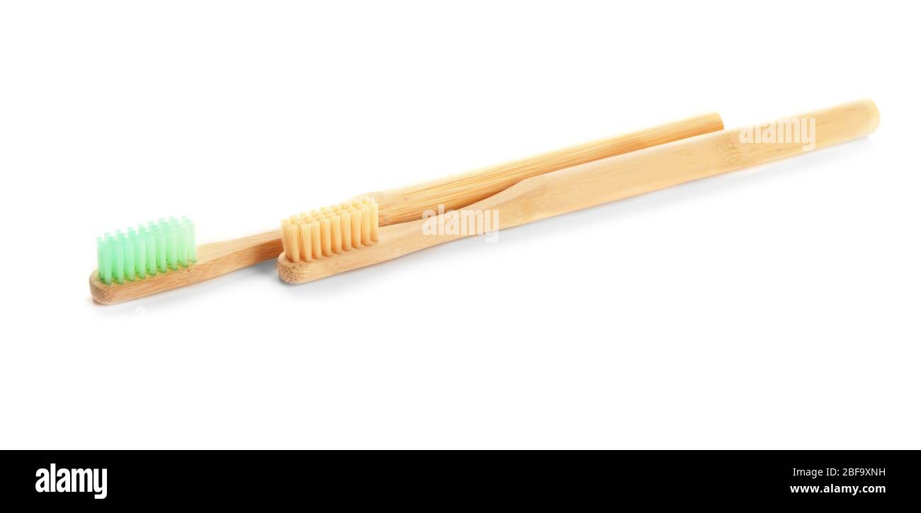 Wooden tooth brushes on white background Stock Photo - Alamy