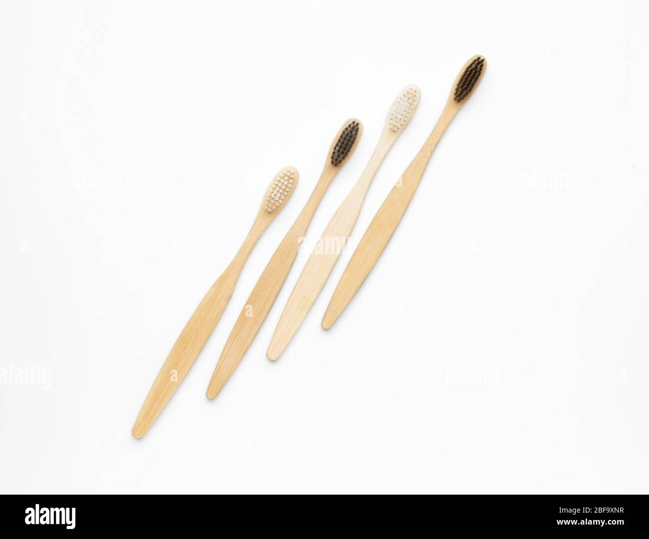 Wooden tooth brushes on white background Stock Photo - Alamy