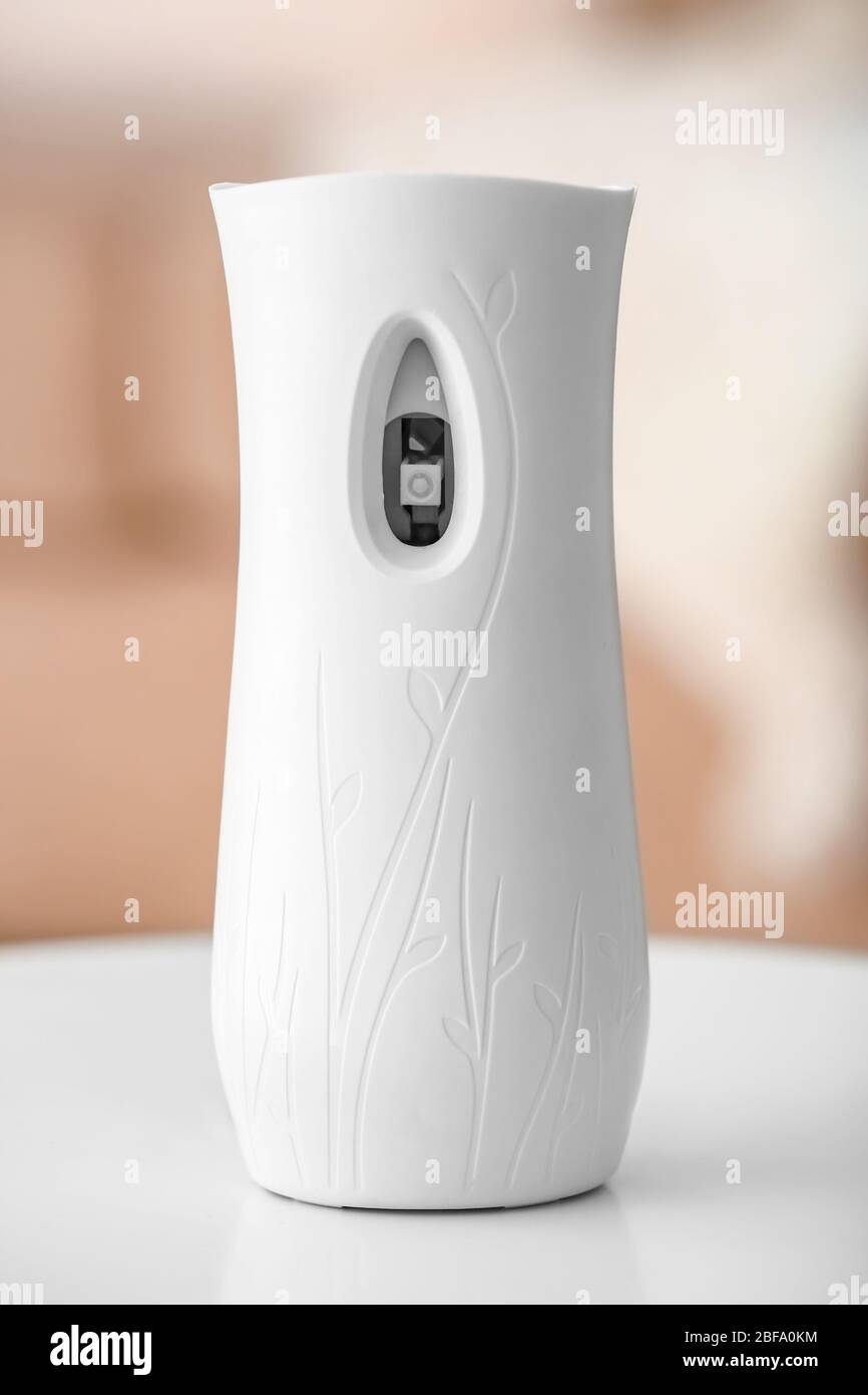 Automatic air freshener on table in room Stock Photo - Alamy