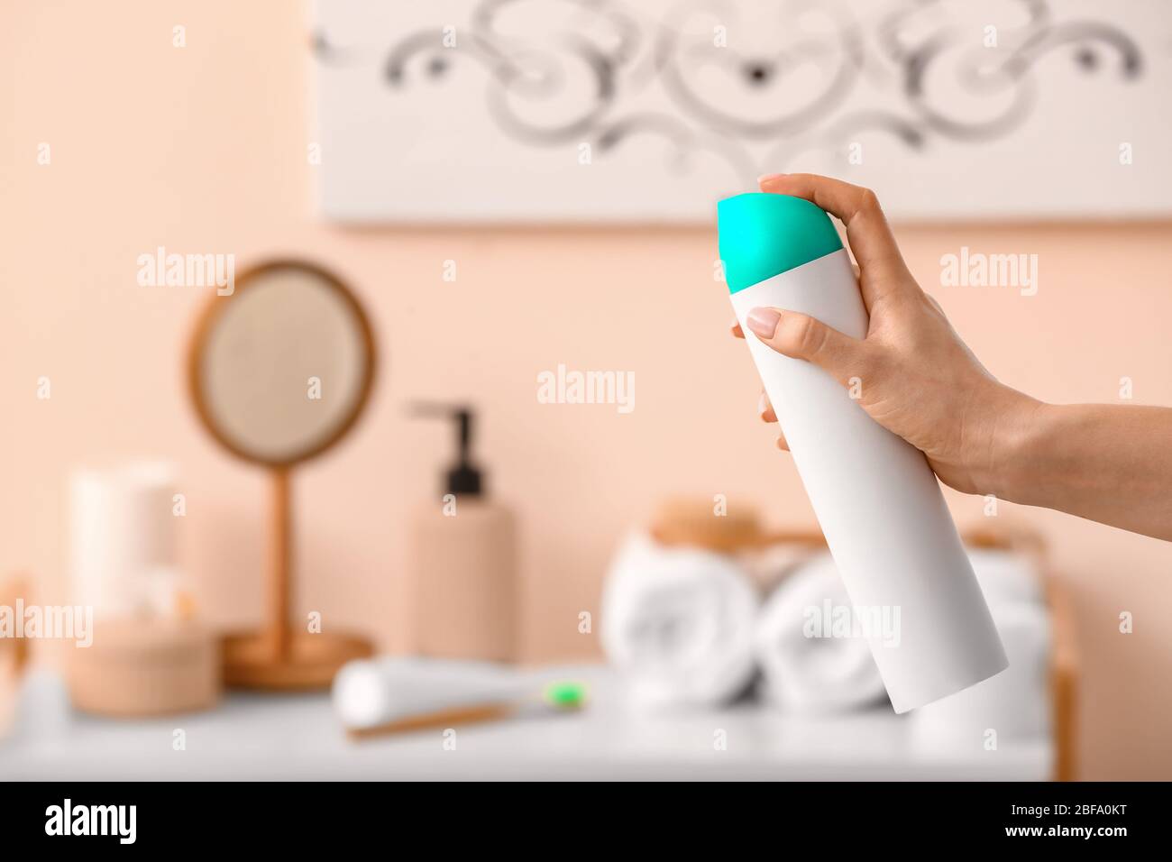 Woman spraying air freshener in room Stock Photo Alamy