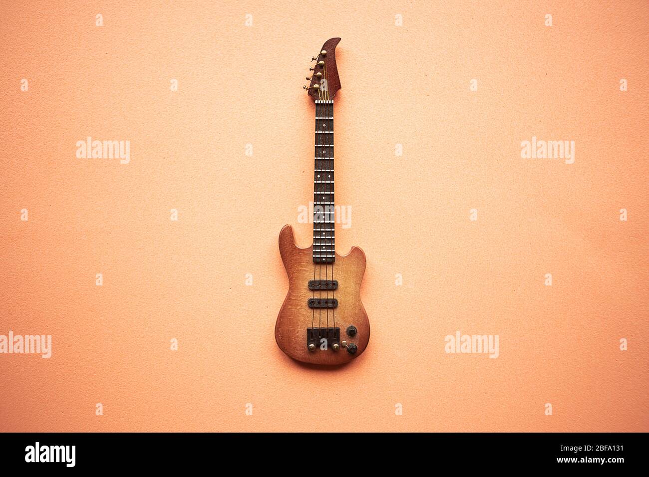 Toy electric bassguitar on pastel pink background Stock Photo Alamy