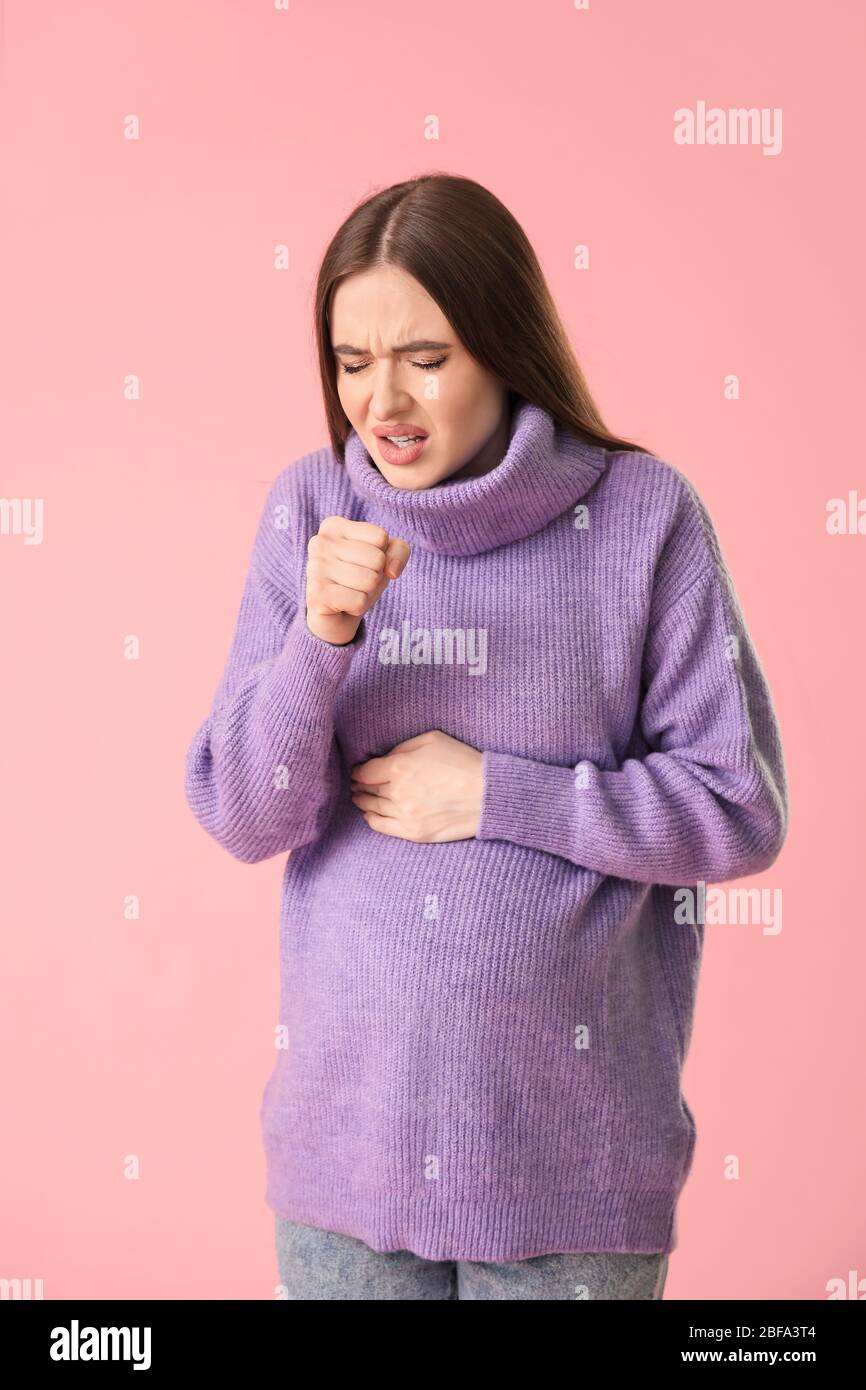 Coughing young pregnant woman on color background Stock Photo Alamy