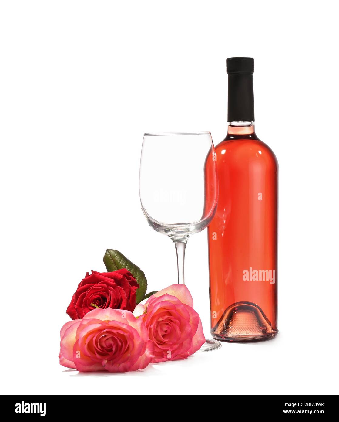 Glass and bottle of wine with rose flowers on white background Stock
