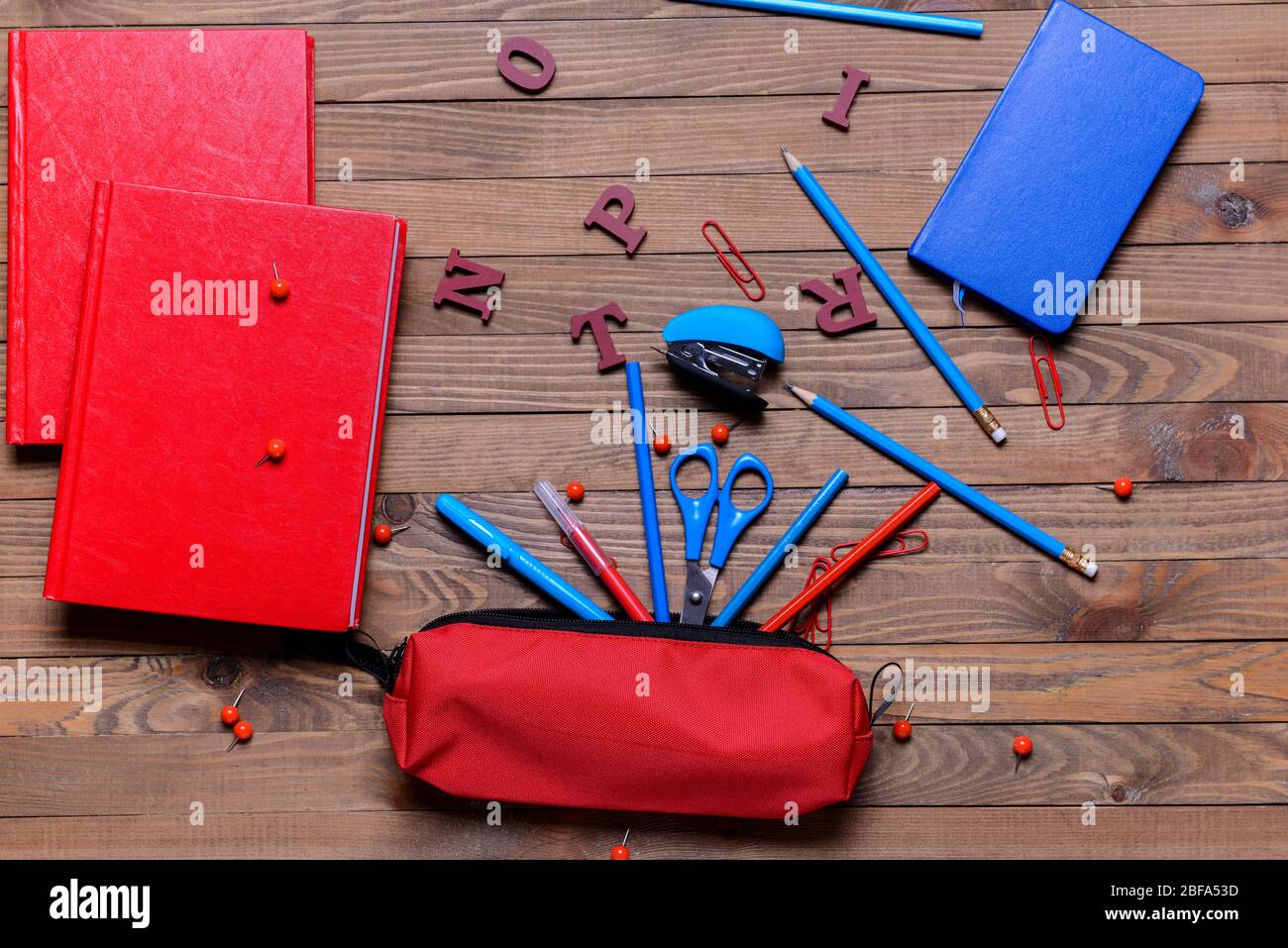 Pencil case and school stationery on wooden background Stock Photo