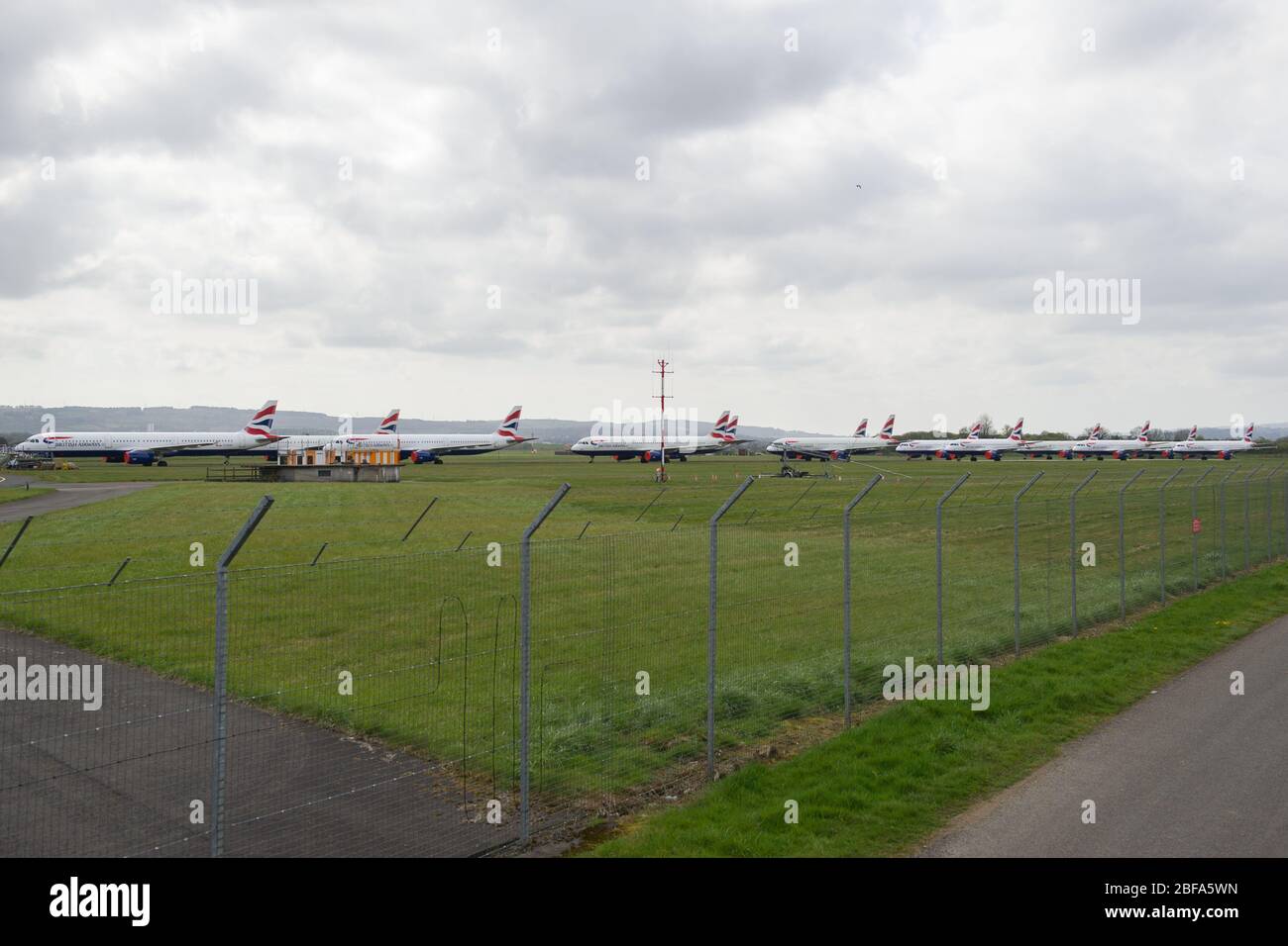 Glasgow, UK. 17th Apr, 2020. Pictured: A collection of fourteen British Airways Jets (short to medium range Airbus Aircraft) ranging from A319, A320 and A321 Jets stand grounded on the tarmac of Glasgow International Airport. The world's aviation industry is experiencing an unprecedented downturn in business with most of the airlines laying off a high amount of staff due to huge financial pressures caused by the ongoing Coronavirus (COVID-19) Pandemic. Credit: Colin Fisher/Alamy Live News Stock Photo