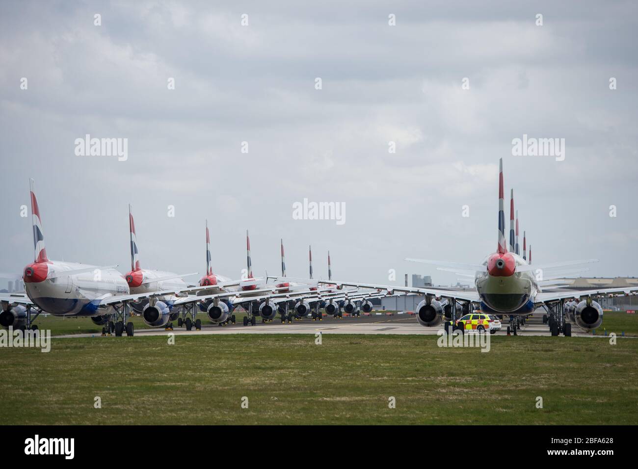 Glasgow, UK. 17th Apr, 2020. Pictured: A collection of fourteen British Airways Jets (short to medium range Airbus Aircraft) ranging from A319, A320 and A321 Jets stand grounded on the tarmac of Glasgow International Airport. The world's aviation industry is experiencing an unprecedented downturn in business with most of the airlines laying off a high amount of staff due to huge financial pressures caused by the ongoing Coronavirus (COVID-19) Pandemic. Credit: Colin Fisher/Alamy Live News Stock Photo