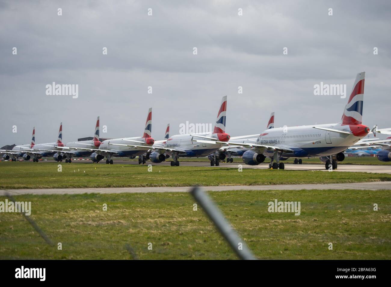 Glasgow, UK. 17th Apr, 2020. Pictured: A collection of fourteen British Airways Jets (short to medium range Airbus Aircraft) ranging from A319, A320 and A321 Jets stand grounded on the tarmac of Glasgow International Airport. The world's aviation industry is experiencing an unprecedented downturn in business with most of the airlines laying off a high amount of staff due to huge financial pressures caused by the ongoing Coronavirus (COVID-19) Pandemic. Credit: Colin Fisher/Alamy Live News Stock Photo