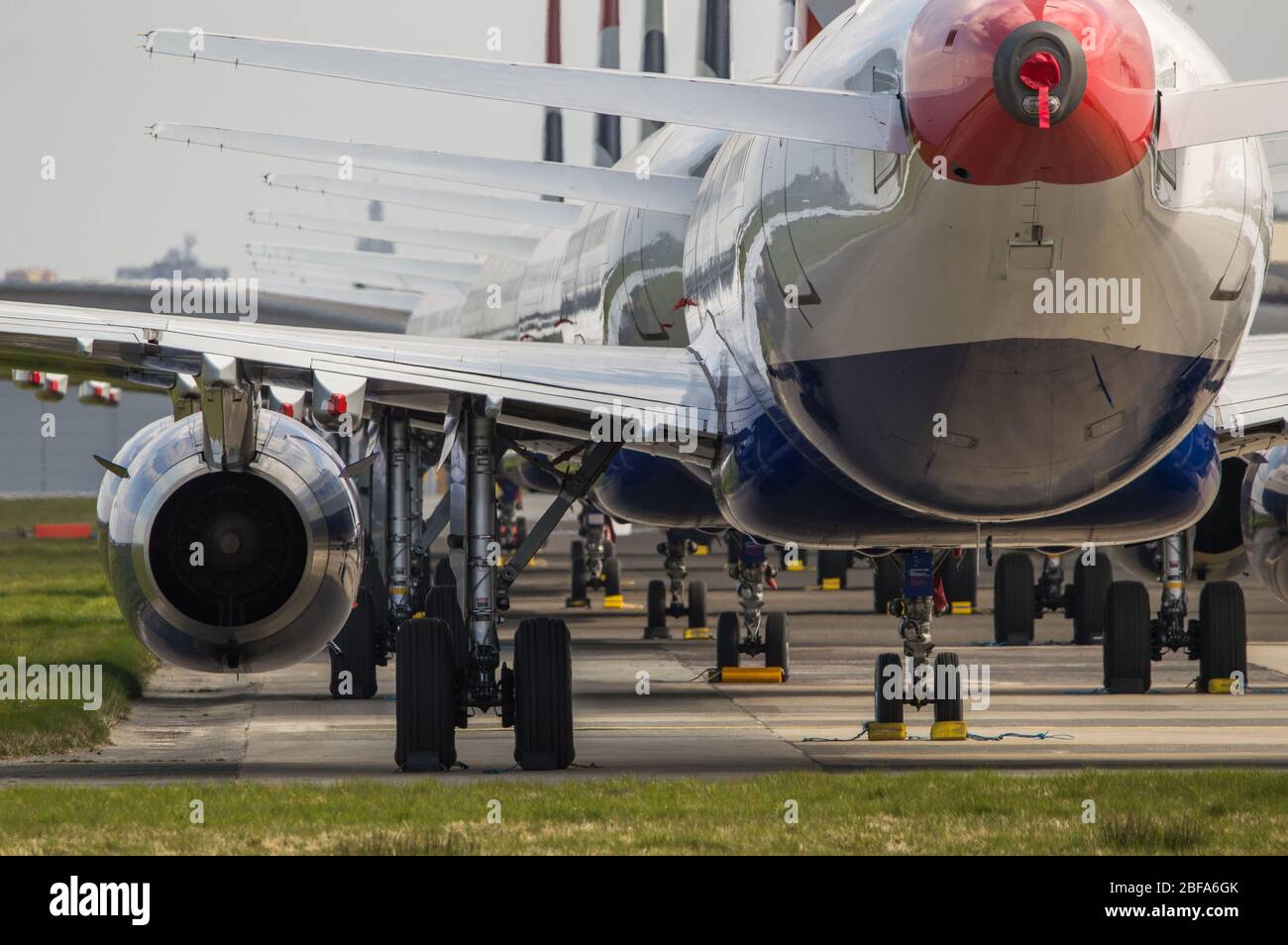 Glasgow, UK. 17th Apr, 2020. Pictured: A collection of fourteen British Airways Jets (short to medium range Airbus Aircraft) ranging from A319, A320 and A321 Jets stand grounded on the tarmac of Glasgow International Airport. The world's aviation industry is experiencing an unprecedented downturn in business with most of the airlines laying off a high amount of staff due to huge financial pressures caused by the ongoing Coronavirus (COVID-19) Pandemic. Credit: Colin Fisher/Alamy Live News Stock Photo