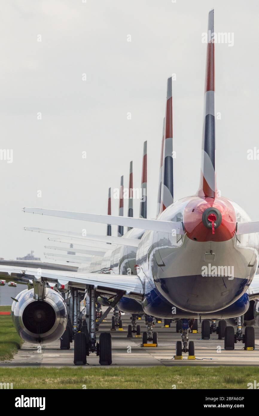 Glasgow, UK. 17th Apr, 2020. Pictured: A collection of fourteen British Airways Jets (short to medium range Airbus Aircraft) ranging from A319, A320 and A321 Jets stand grounded on the tarmac of Glasgow International Airport. The world's aviation industry is experiencing an unprecedented downturn in business with most of the airlines laying off a high amount of staff due to huge financial pressures caused by the ongoing Coronavirus (COVID-19) Pandemic. Credit: Colin Fisher/Alamy Live News Stock Photo