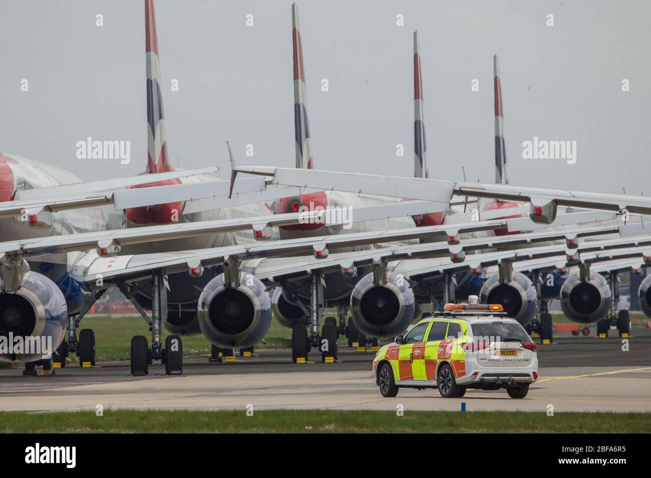 Glasgow, UK. 17th Apr, 2020. Pictured: A collection of fourteen British Airways Jets (short to medium range Airbus Aircraft) ranging from A319, A320 and A321 Jets stand grounded on the tarmac of Glasgow International Airport. The world's aviation industry is experiencing an unprecedented downturn in business with most of the airlines laying off a high amount of staff due to huge financial pressures caused by the ongoing Coronavirus (COVID-19) Pandemic. Credit: Colin Fisher/Alamy Live News Stock Photo