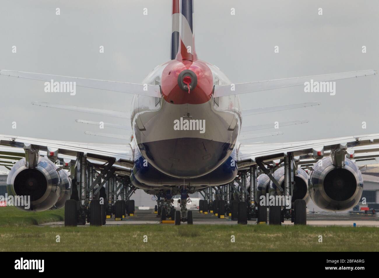 Glasgow, UK. 17th Apr, 2020. Pictured: A collection of fourteen British Airways Jets (short to medium range Airbus Aircraft) ranging from A319, A320 and A321 Jets stand grounded on the tarmac of Glasgow International Airport. The world's aviation industry is experiencing an unprecedented downturn in business with most of the airlines laying off a high amount of staff due to huge financial pressures caused by the ongoing Coronavirus (COVID-19) Pandemic. Credit: Colin Fisher/Alamy Live News Stock Photo