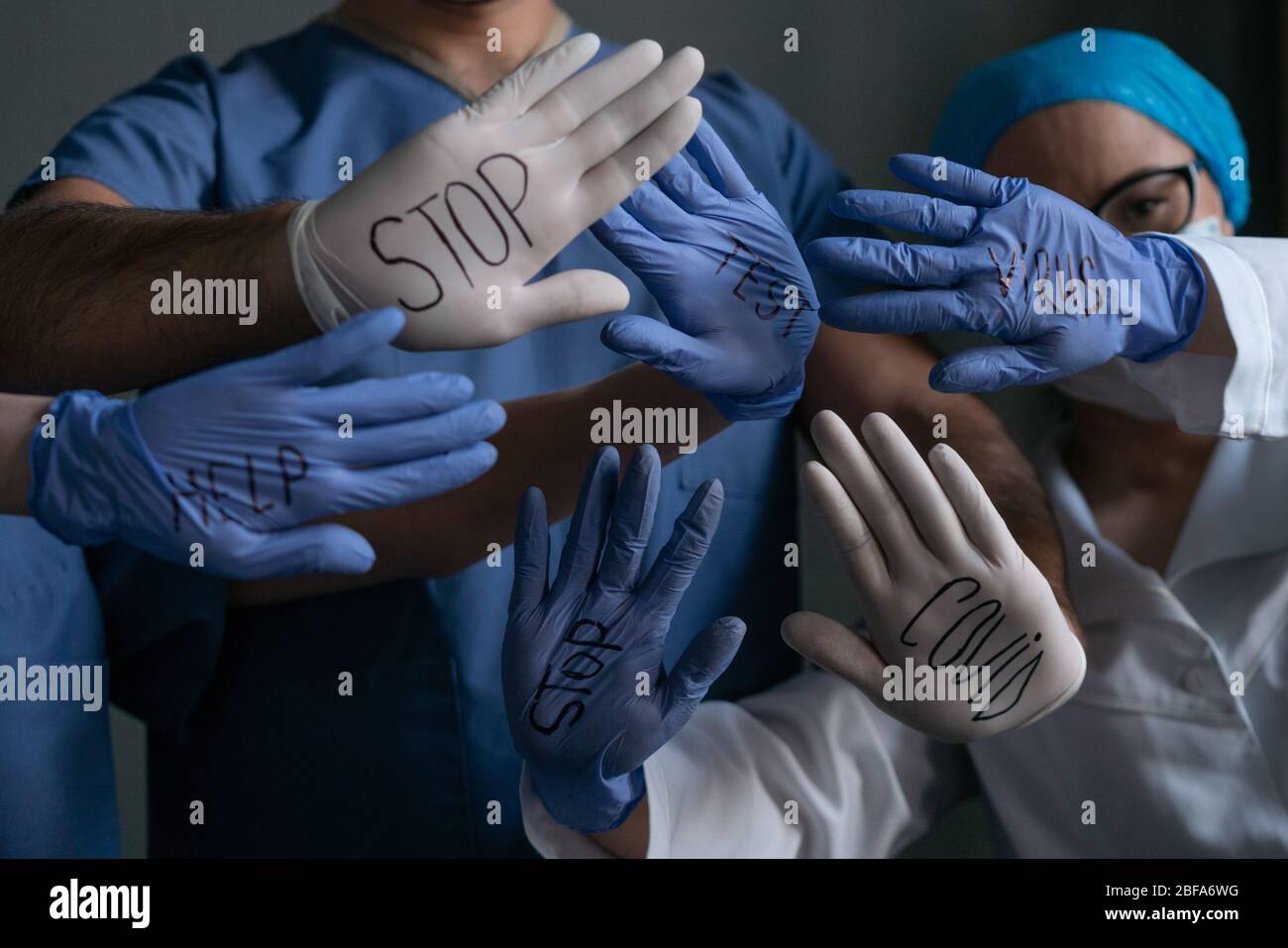 Group Of Medic Shows Titles Written On Their Gloves Stock Photo