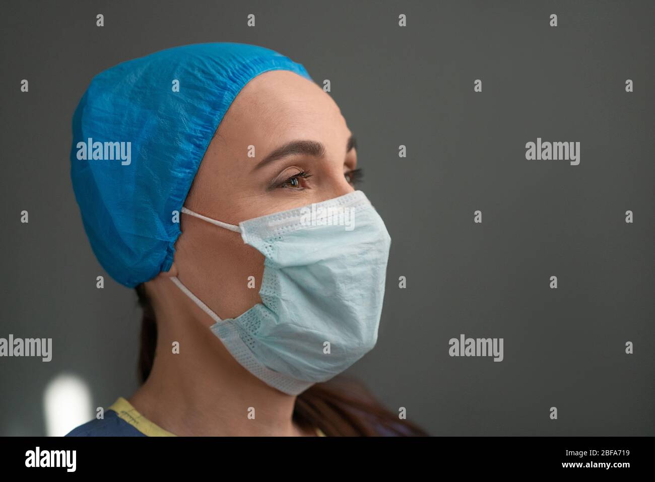 Portrait Of Young Female Medic In Protective Mask Stock Photo
