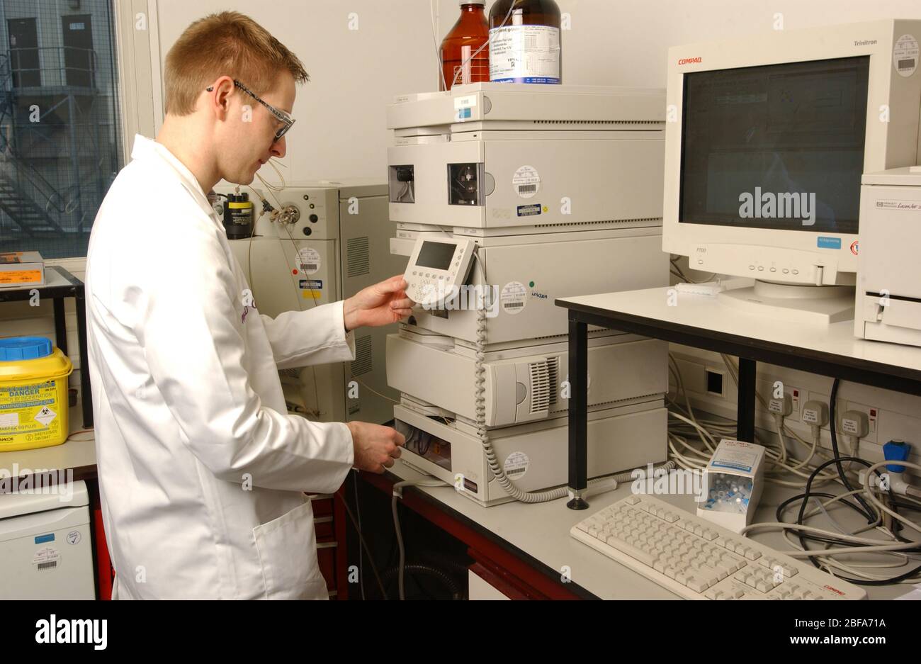 Laboratory assistant analyses a computer readout. Stock Photo