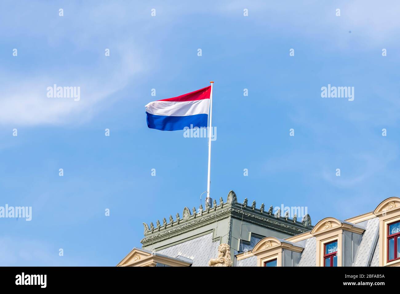 red blue flag with building