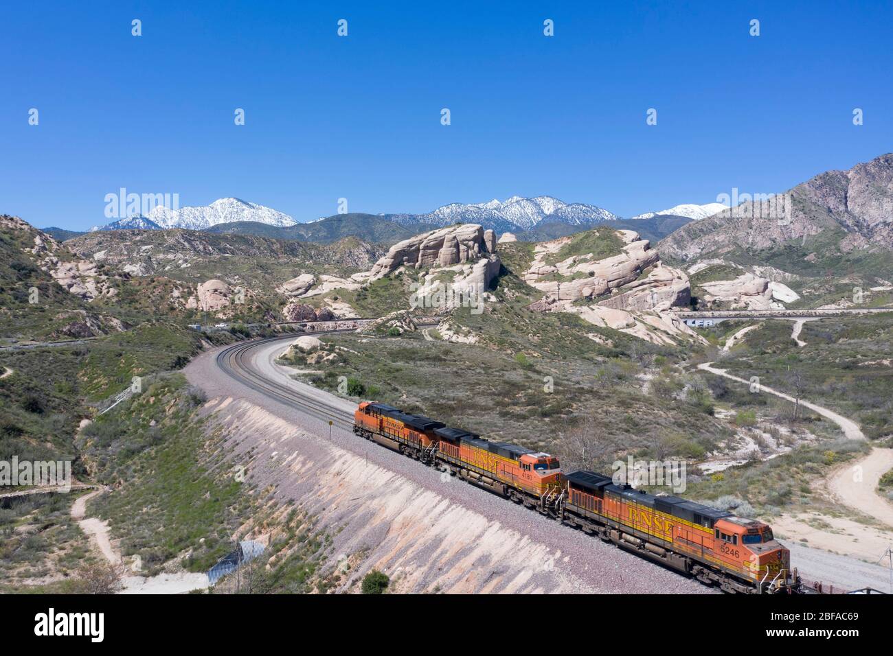 Freight train climbing the grade at Cajon Pass in San Bernardino County, part of the large logistics chain of Southern California Stock Photo