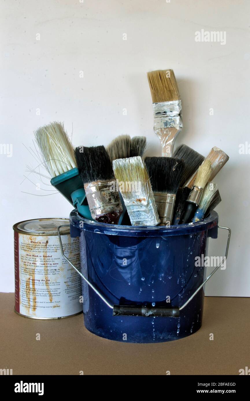 Used paint brushes standing in a paint holder bucket Stock Photo Alamy