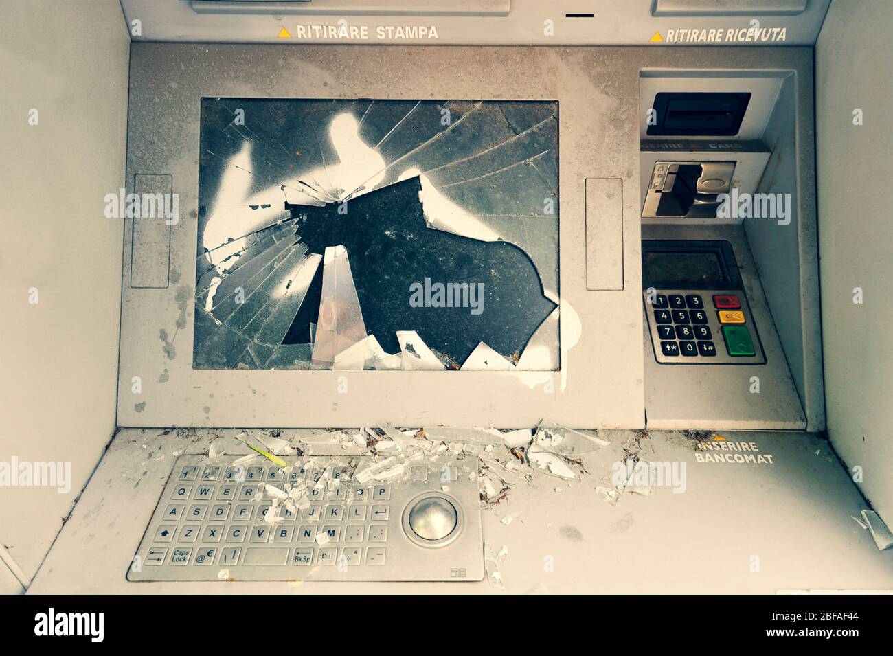 Damaged, vandalised, abandoned ghost ATM, out of order destroyed cash machine. Front view of broken, out of service auto teller machine with cracked s Stock Photo
