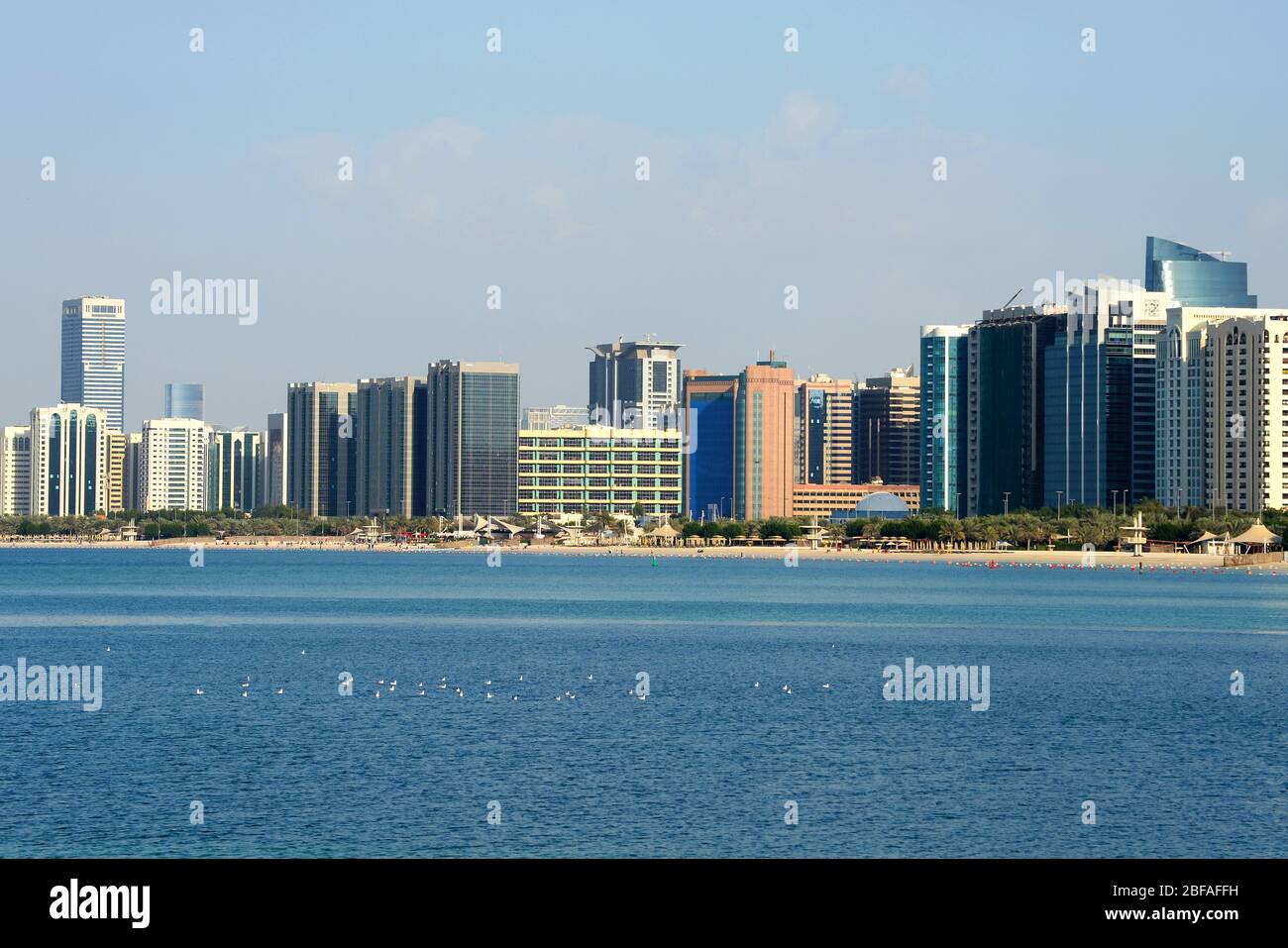 Skyline of Abu Dhabi, United Arab Emirates with multiple skyscrapers. Multiple modern buildings with mirrored glass in the Corniche. Stock Photo