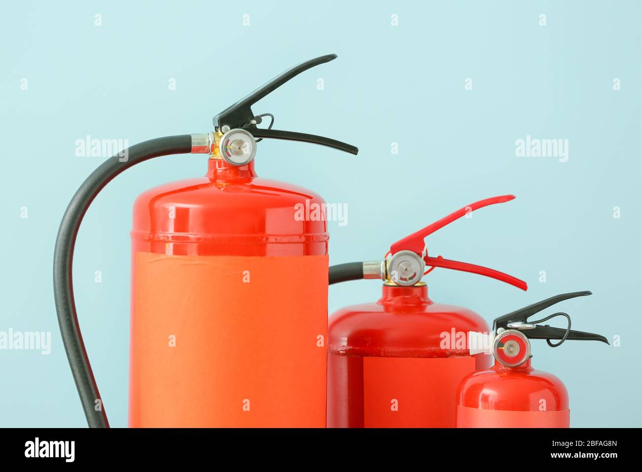 Fire extinguishers on color background Stock Photo - Alamy
