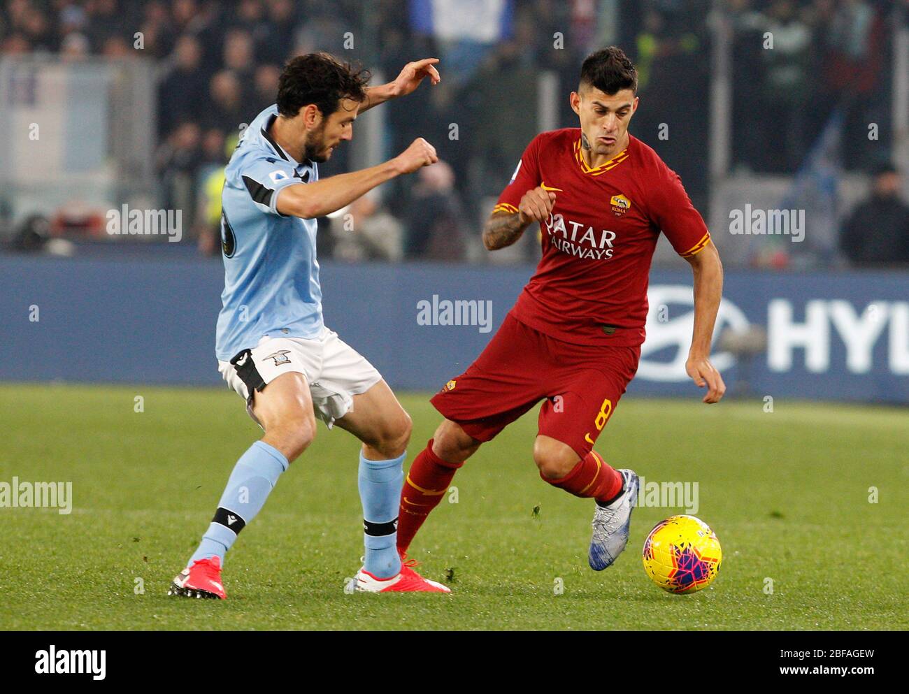 Rome, Italy, January 26, 2020. Roma s Diego Perotti, right, is challenged by Lazio s Marco Parolo during the Serie A soccer match between Roma and Lazio at the Olympic Stadium. Stock Photo