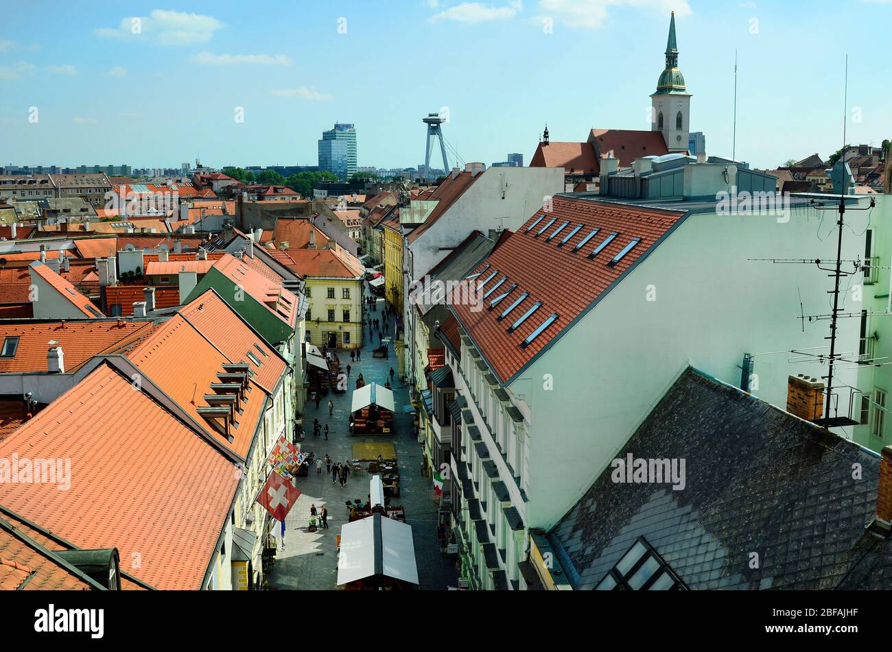 Slovakia, Bratislava - May 28th 2015: Unidentified people, restaurants and buildings in Michalska street and the landmarks bridge novy most and martin Stock Photo