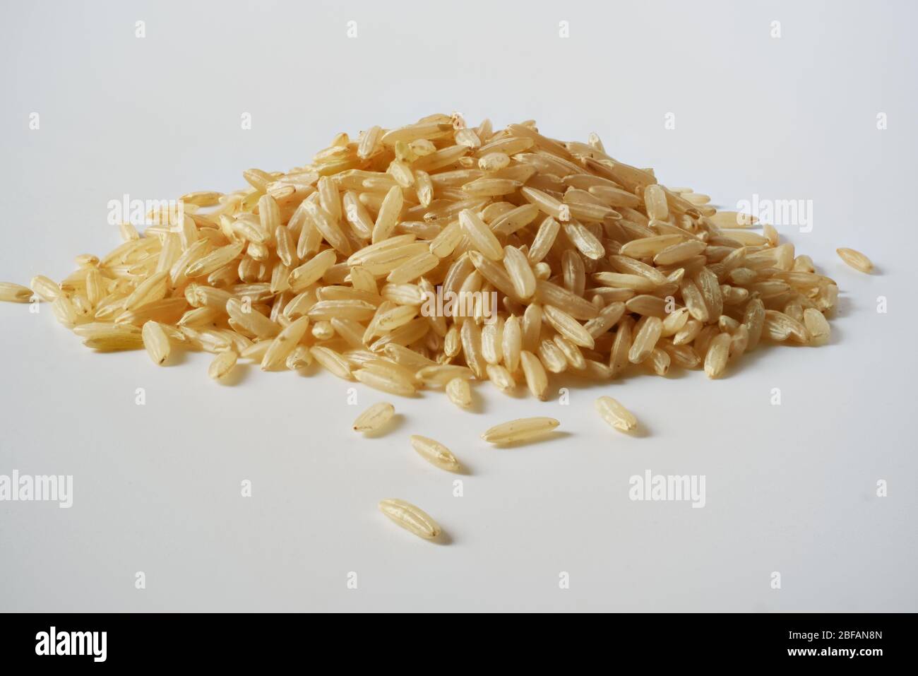 macro view of heap of rice isolated on white background Stock Photo - Alamy