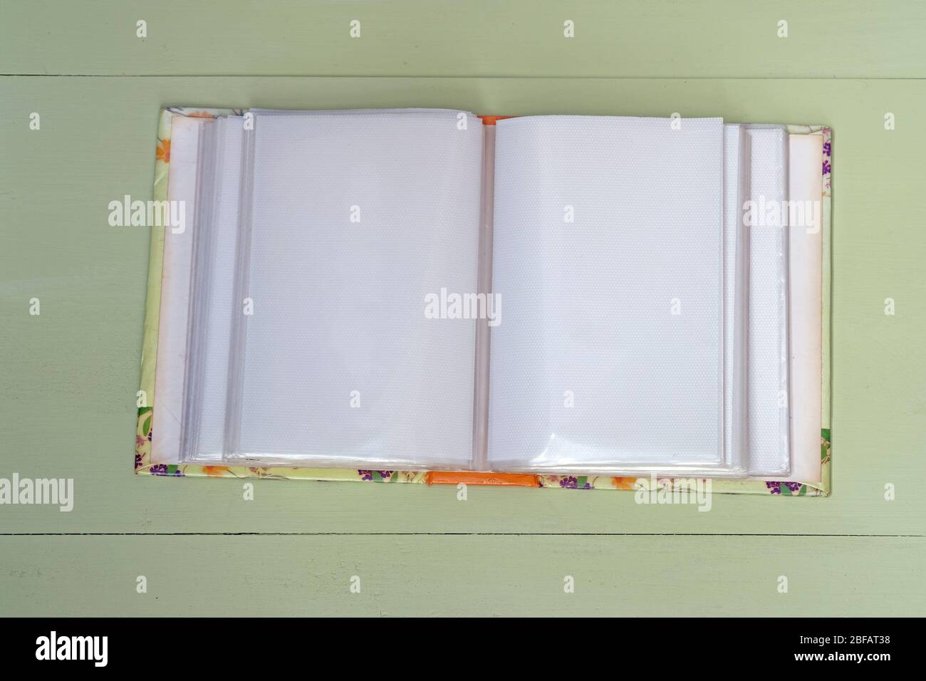 Old empty photo album on wooden background. White sheets with a film ...