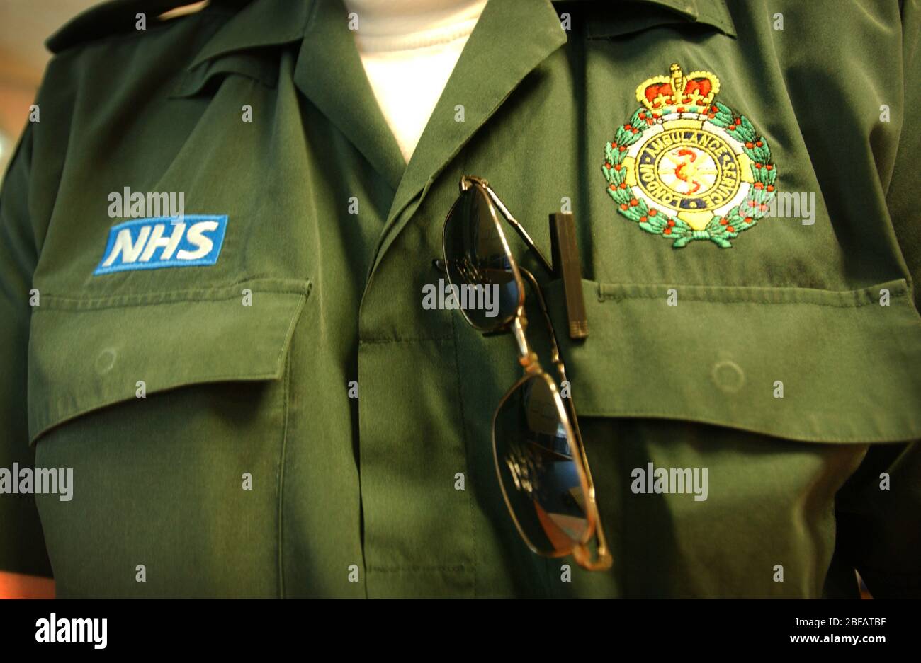 National Health Service ambulance crew green uniform Stock Photo - Alamy