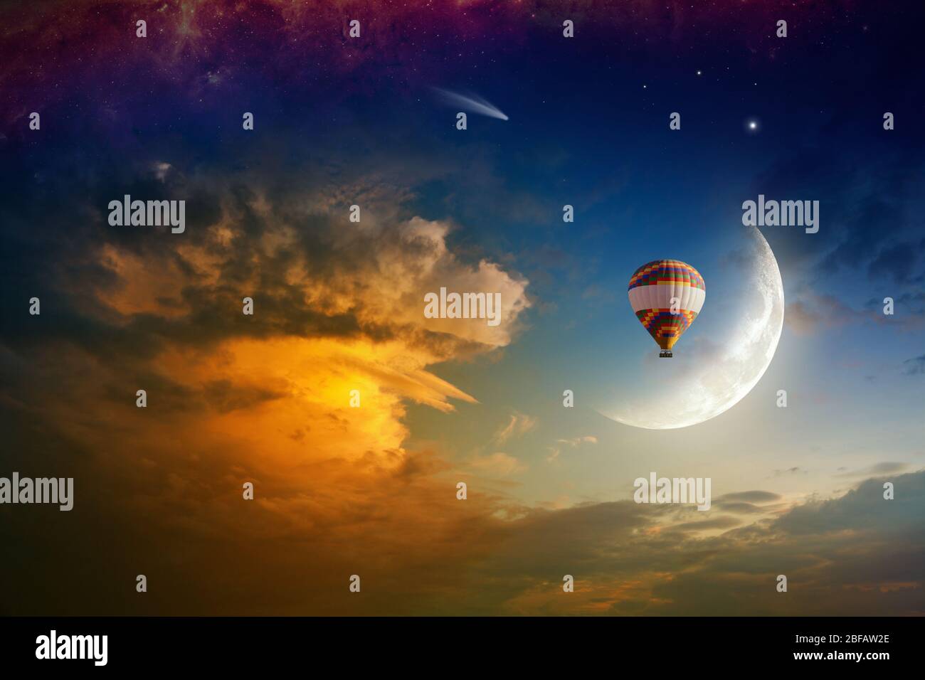 Colorful hot air balloon rises very high in sunset sky above glowing ...