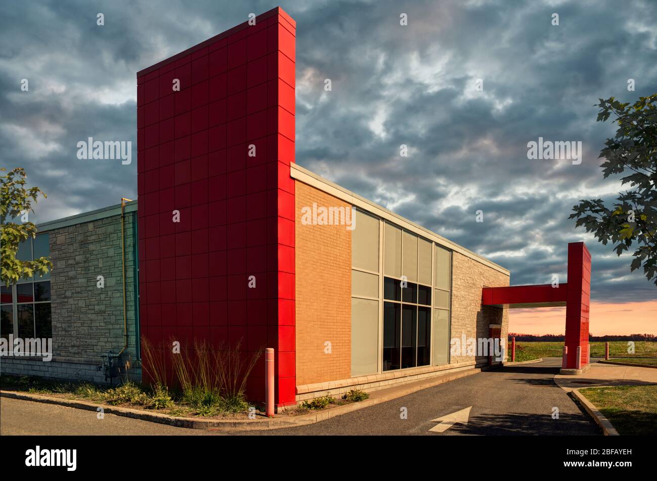 Bank drive thru on a summer day, cloudy sky in background. Stock Photo