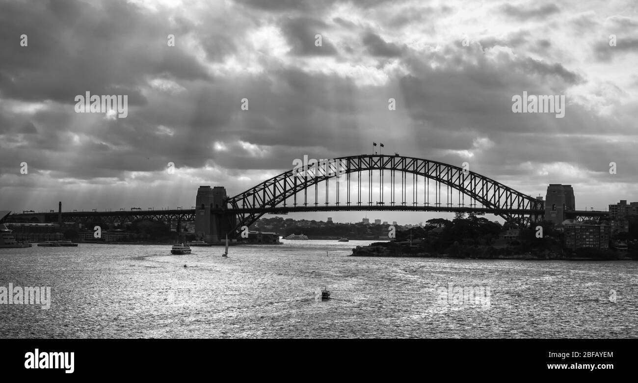 Panoramic view of the Sydney Harbour Bridge under a dramatic day, black and white Stock Photo