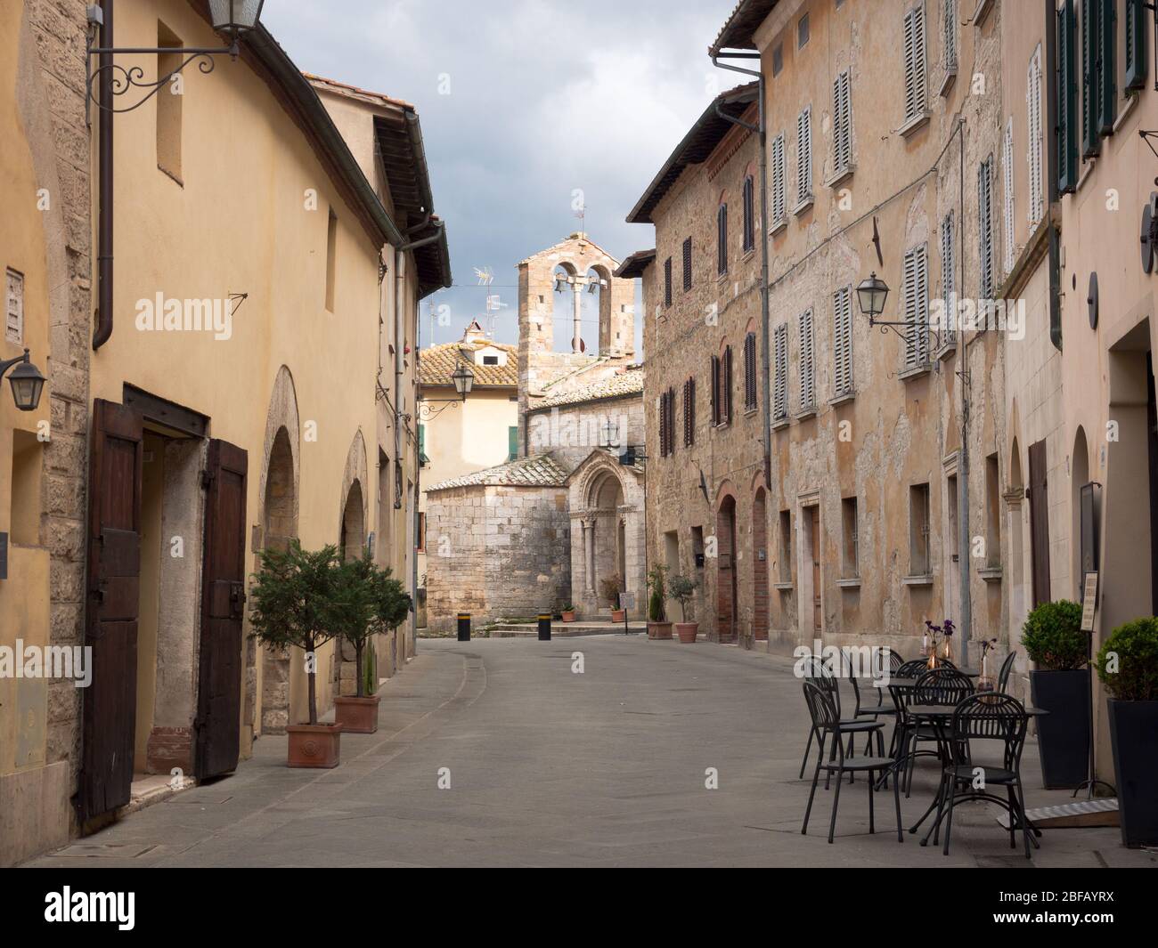 Ancient stone church in San Quirico D'Orcia, a medieval village in the Tuscan hills. Stock Photo