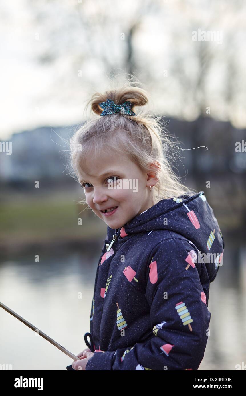 Beautiful cute little girl with a grimace on her face, happy childhood and children's emotions Stock Photo