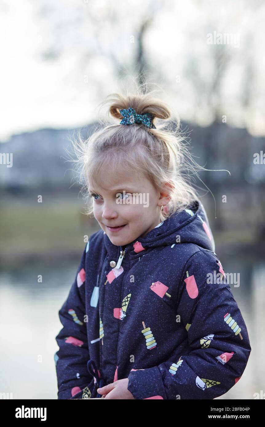 Beautiful cute little girl with a grimace on her face, happy childhood and children's emotions Stock Photo