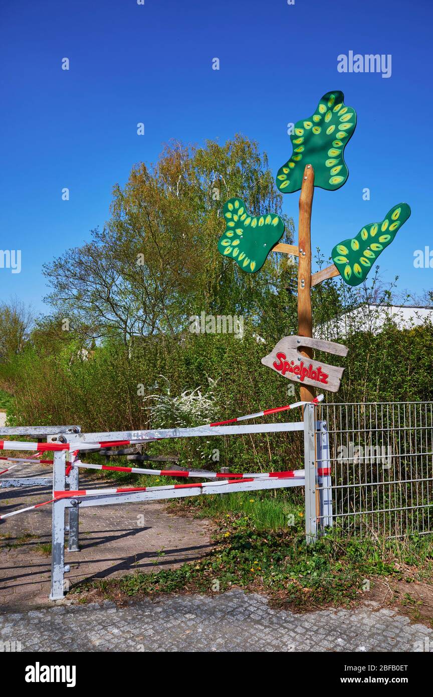 Children's playground in Berlin, Germany, which was closed due to the Covid-19 virus and the blocking of contact with a barrier tape. The text means p Stock Photo
