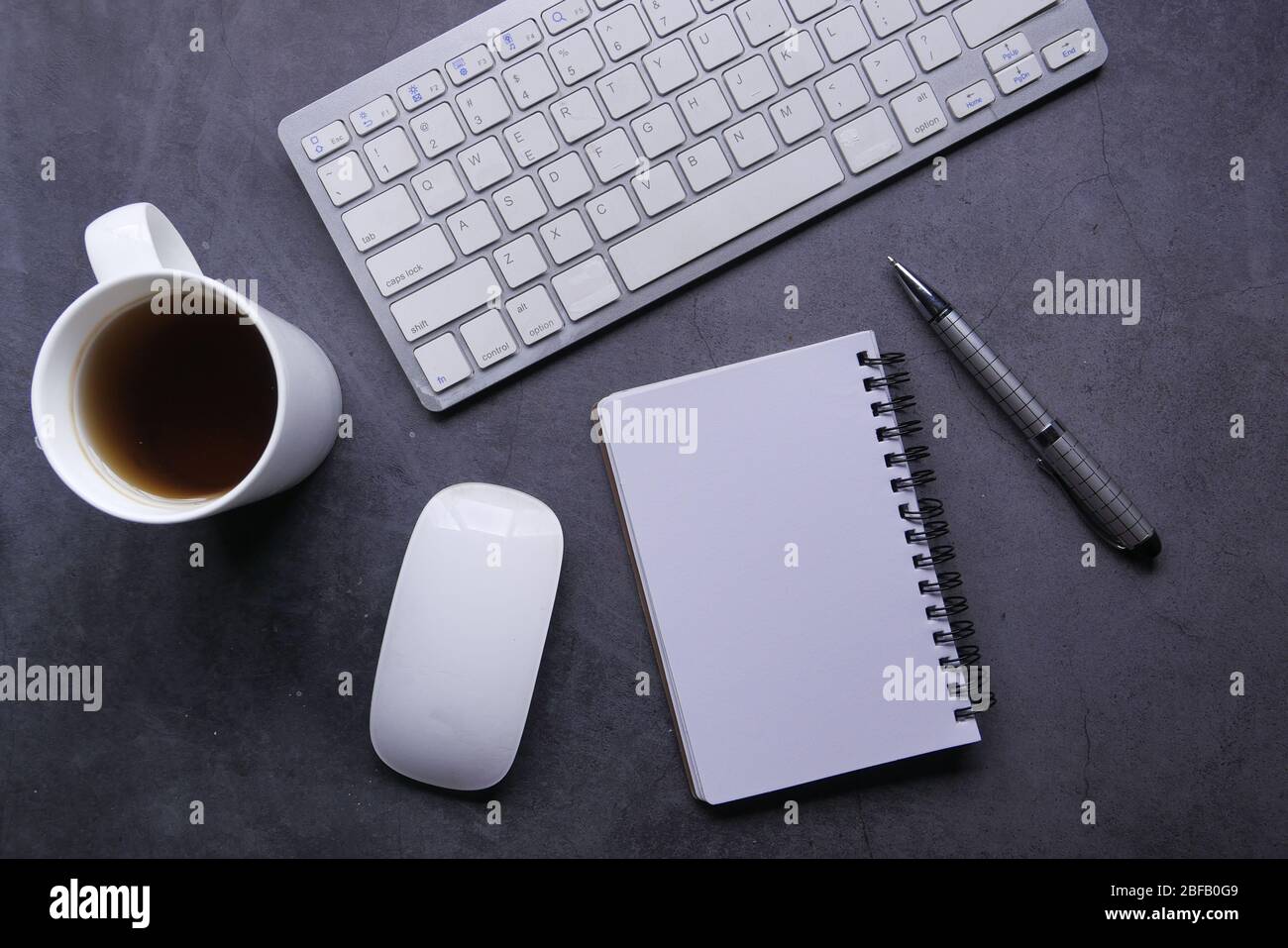 high angle view of notepad keyboard and mouse on table  Stock Photo