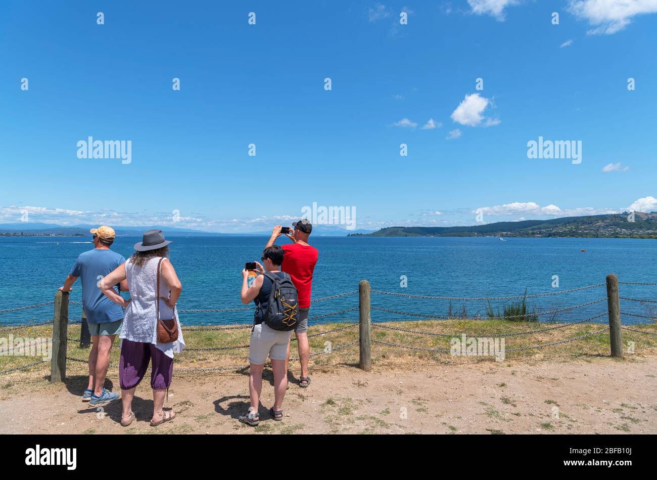 Tourists on the lakefront in Taupo, Lake Taupo, New Zealand Stock Photo