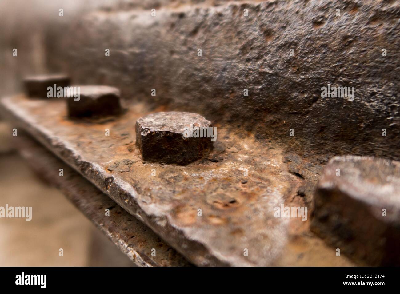 A row of rusty bolts on an old machinery Stock Photo