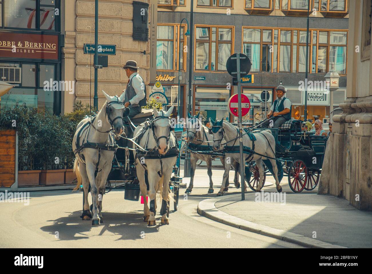 Vienna, Austria - July 27, 2015: Horse-drawn carriages at modern streets of Vienna Stock Photo