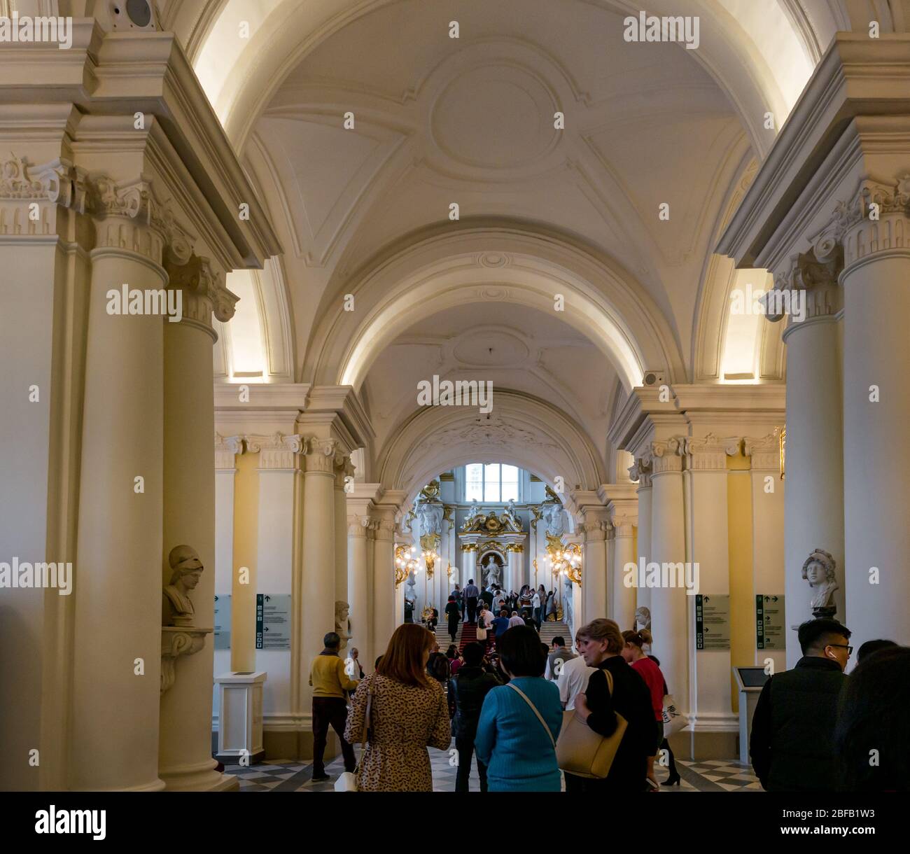 Visitors in corridor leading to Jordan or Ambassadors grand staircase, Hermitage State Museum, St Petersburg, Russian Federation Stock Photo