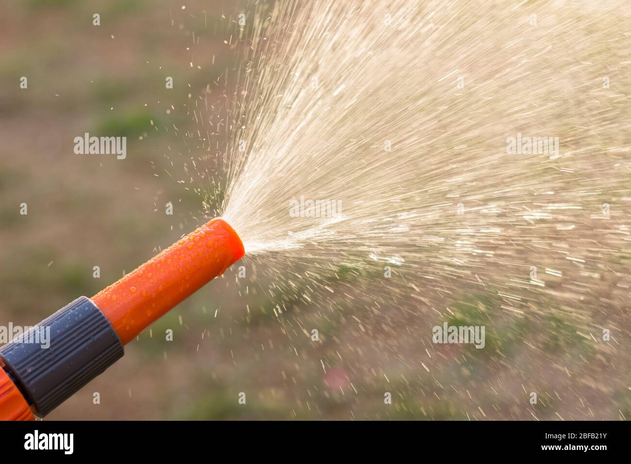 Water splash hose in garden Stock Photo