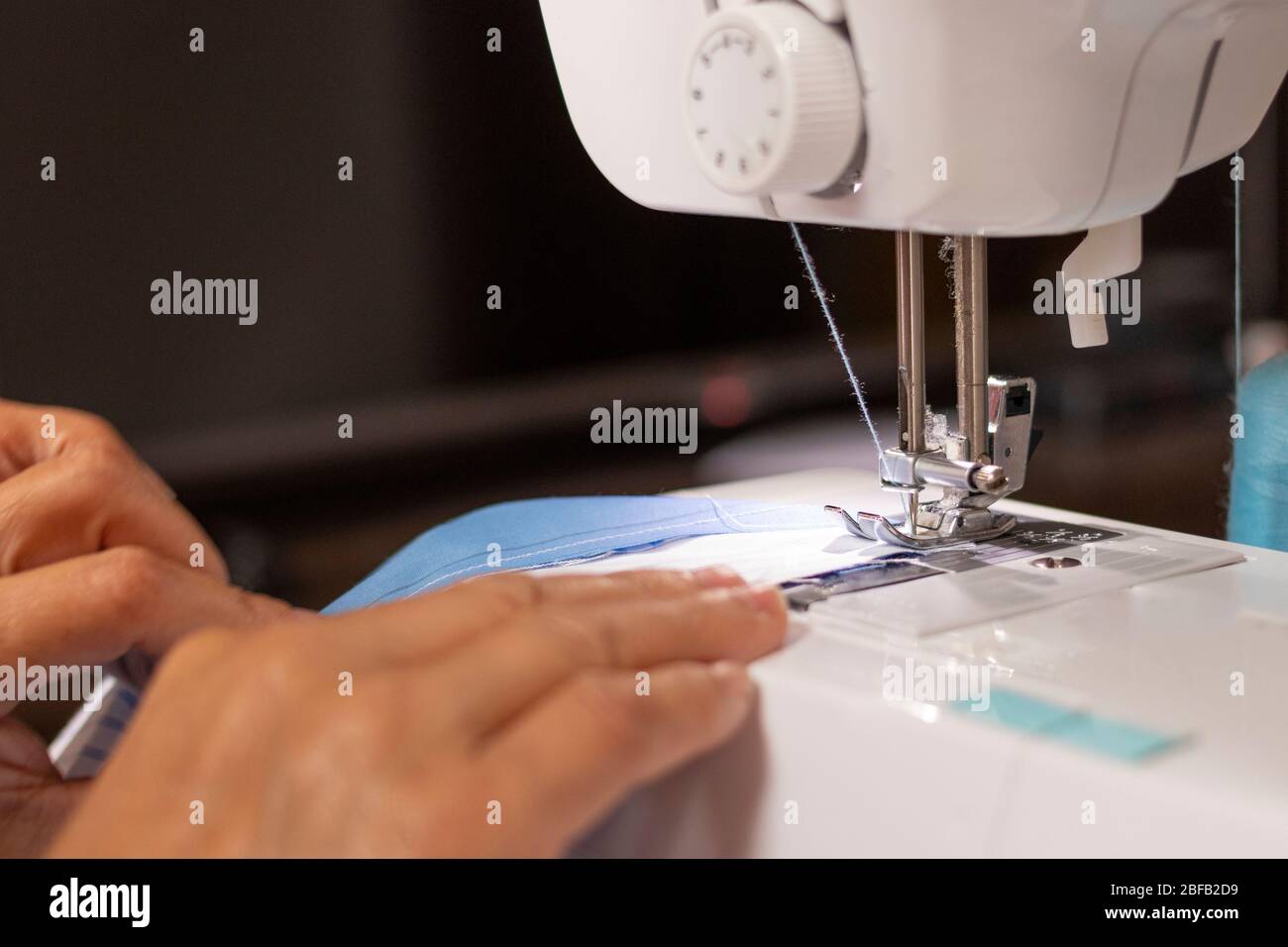 Sewing machine worked by a seamstress Stock Photo Alamy