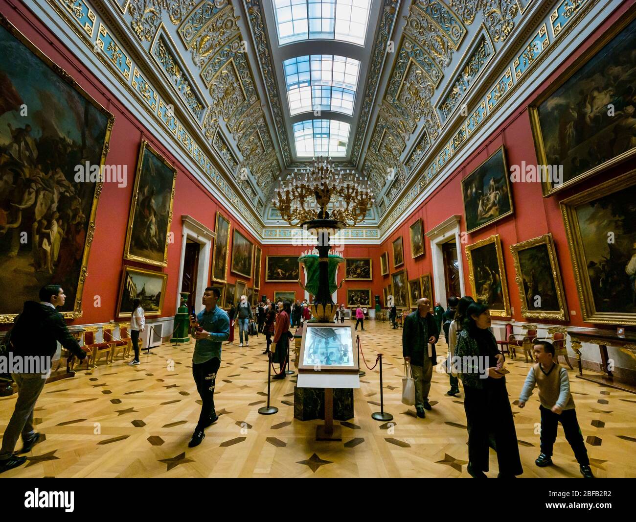 Tourists looking at paintings in Italian Skylight Room, Hermitage State Museum, St Petersburg, Russian Federation Stock Photo