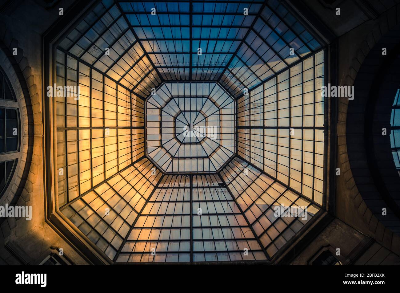 Milan, Italy, September 8, 2018: Glass and iron patterned ceiling roof of huge dome of shopping mall, view from below, Milano city Stock Photo