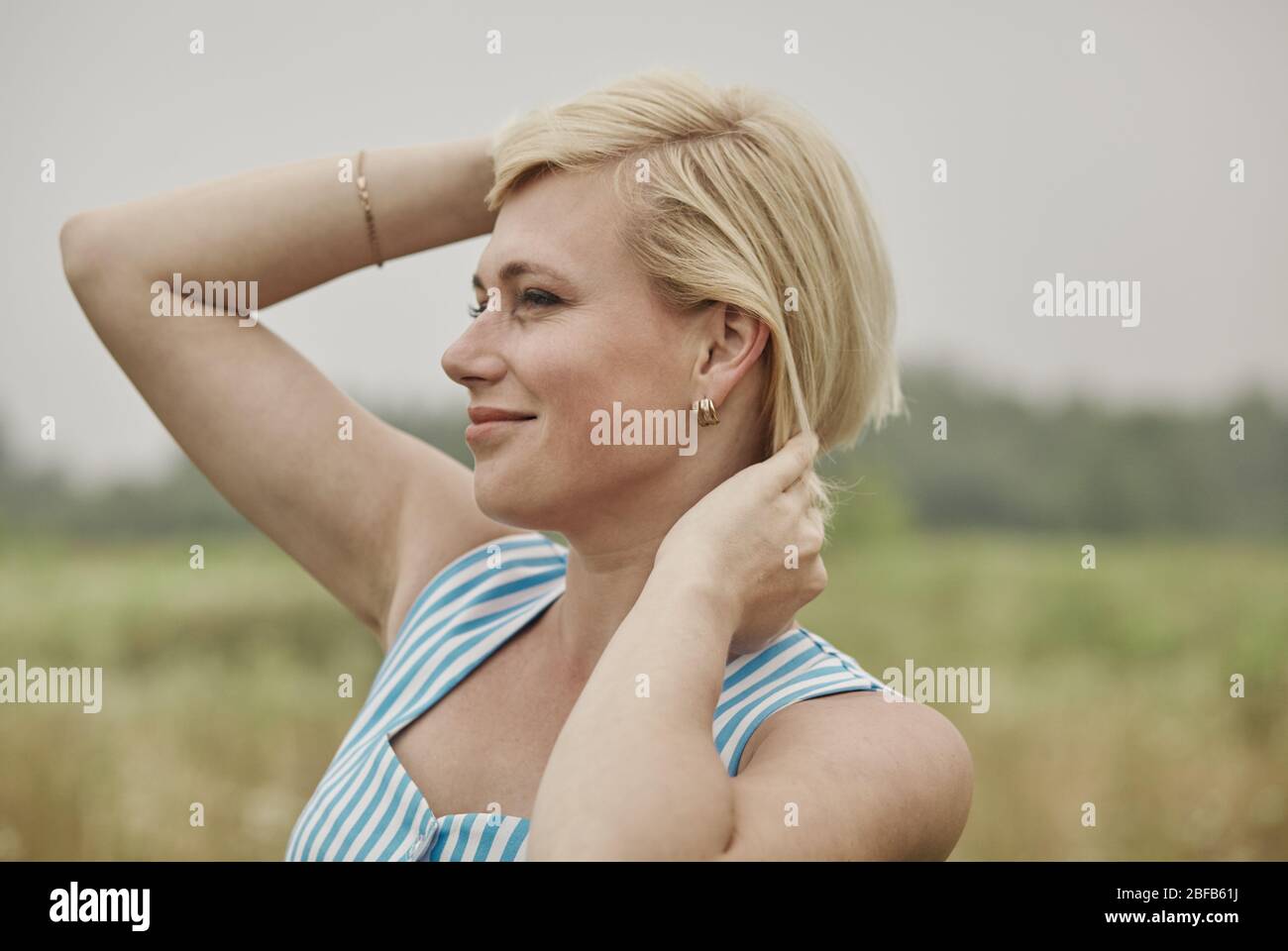 Happy woman relaxing in summer in beautiful field Stock Photo - Alamy