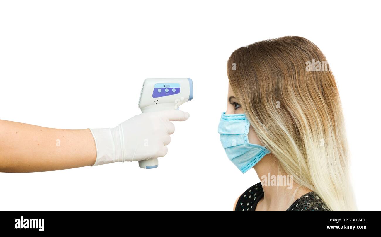 Usage of infrared noncontact forehead thermometer gun to check body temperature for virus covid