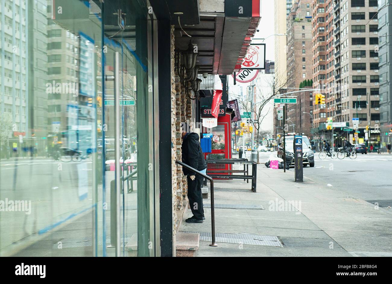 A man looking in a closed restaurant window during the COVID19 pandemic in New York City. Stock Photo