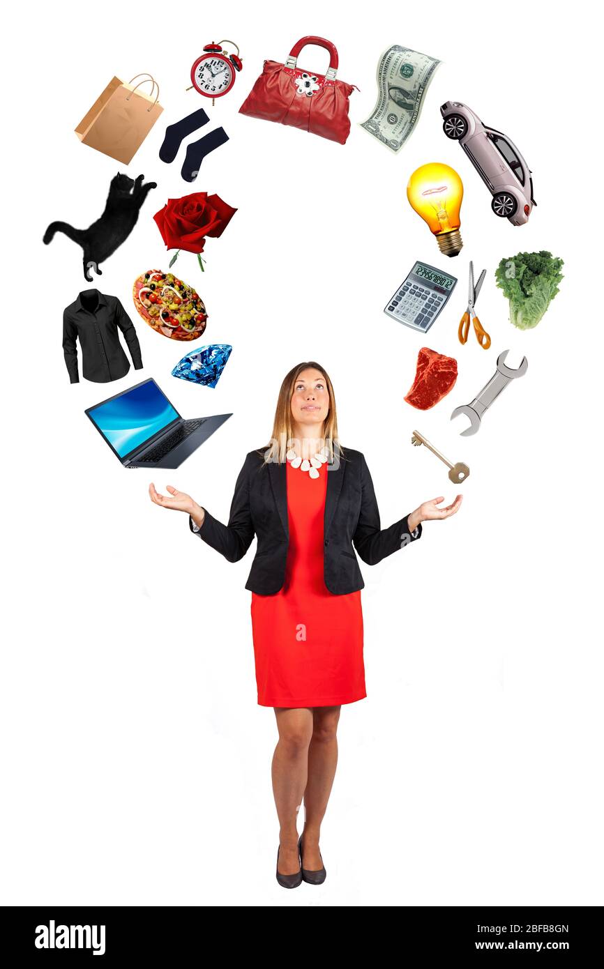 Woman with a lot of objects flying above her. Desires and dreams. White backgorund. A beautiful woman has in her hands the objects of her desires. Stock Photo