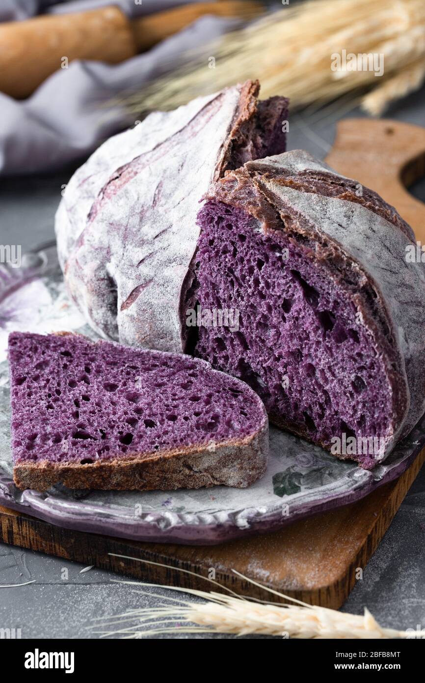 Home made purple bread and stalks of wheat Stock Photo
